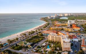 an aerial view of a resort and the beach at Le Vent Eagle Beach Condos by Bocobay Aruba in Palm-Eagle Beach