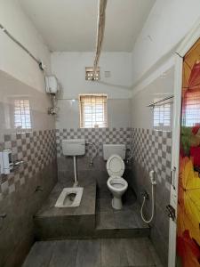 a bathroom with a toilet and a sink at Sunlight Premium in Bhubaneshwar