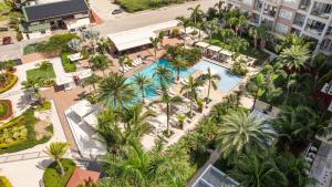 an overhead view of a resort with a pool and palm trees at Le Vent Eagle Beach Condos by Bocobay Aruba in Palm-Eagle Beach