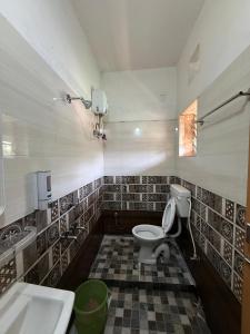 a bathroom with a toilet and a sink at Sunlight Premium in Bhubaneshwar