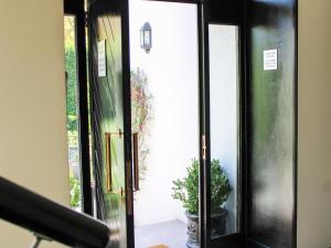 an open door to a room with a potted plant at Oak Manor Boutique Guest House in Cape Town