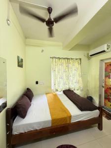 a bedroom with a bed and a ceiling fan at Sunlight Premium in Bhubaneshwar