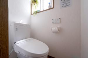 a bathroom with a toilet and a roll of toilet paper at 一隅居 in Yaochō +41 photos
