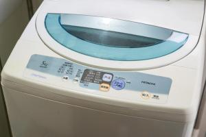 a washing machine with a microwave on top of it at 一隅居 in Yaochō