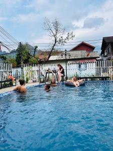 a group of people in a swimming pool at Rock Backpackers Central Hostel in Vang Vieng