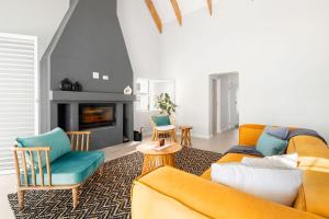 a living room with a couch and a fireplace at Sugarbird in Velddrif