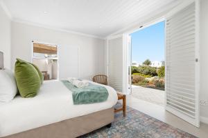 a bedroom with a bed and a large window at Sugarbird in Velddrif
