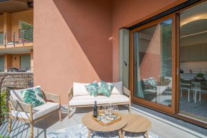 a patio with two chairs and a table and a table at Magical Menaggio Vista in Menaggio