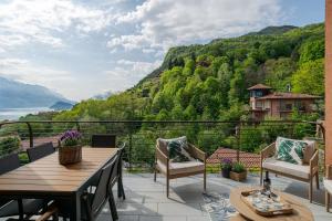 a balcony with a table and chairs and a view at Magical Menaggio Vista in Menaggio