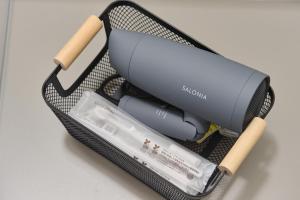 a black lunch box with a blow dryer and aimeter at Hotel GGG Asahikawa in Asahikawa