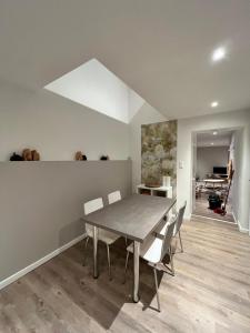 a dining room with a table and chairs at Le Cosy Duplex in Amay +11 photos