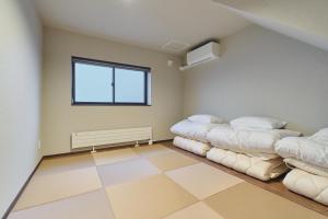 a room with two beds in it with a window at Hotel GGG Asahikawa in Asahikawa +49 photos