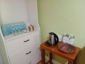 a room with a dresser and a table with water bottles at Island - Escape Homestay in Burgos