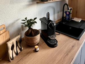 a coffee maker on a counter next to a plant at Simply Enjoy Ferienwohnungen in Losheim