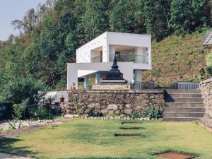 a house on the side of a hill at White Leaf Resort - Green River View Resort in Dolālghāt