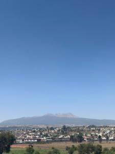 a view of a city with mountains in the background at PH 41 Metepec in Toluca +3 photos