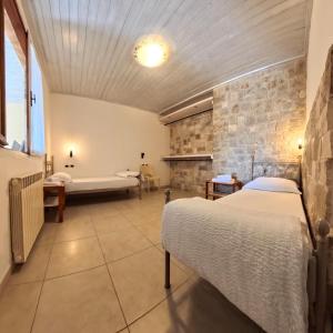 a bedroom with two beds and a tub in a room at Villa Arianna Lake View Apartments with Pool in Tignale +53 photos