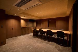 a conference room with a long table and chairs at 開土 KAIDO Hotel in Sapporo