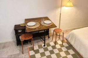 a dining room table with two plates and two chairs at La cassetta 22 in Castelnuovo dellʼAbate
