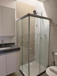 a shower with a glass door in a bathroom at Casa condominio Carpe Diem in Marechal Deodoro +35 photos
