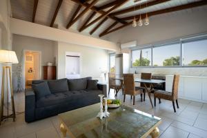 a living room with a couch and a table at Le petit luxury apartment in Preveza