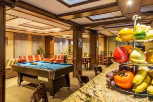 a room with a pool table in a hotel room at Chateau Montagne Hotel Troyan in Troyan