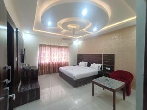 a bedroom with a bed and a table in a room at Hotel Rajwada palace in Orchha +76 photos