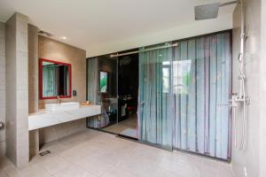 a bathroom with a glass shower and a sink at Tina 5 hotel cần thơ in Ấp Phú Thạnh (4) +159 photos