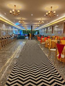 a lobby with a black and white striped carpet at Hotel Rajwada palace in Orchha