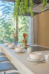 a long table with cups and saucers on it at Aldea Mayab Luxury Residences by Lagoona in Bacalar +254 photos