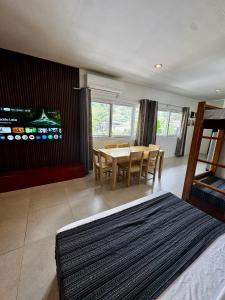 a bedroom with a table and a dining room at Lakambini Transient in El Nido
