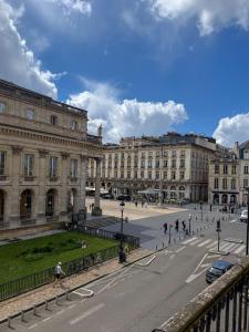 a street in front of a large building at Hotel de L'Opéra in Bordeaux