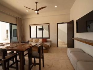 a living room with a dining table and a couch at Casa Norte – Oceanfront Villa in Placencia +32 photos