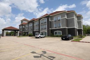 a large building with cars parked in a parking lot at La Quinta by Wyndham Pearland in Pearland