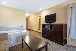 a living room with a couch and a flat screen tv at Comfort Suites Wisconsin Dells Area in Portage