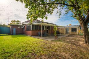 a home with a large yard in front of it at Red Brick Beauty - Central Cottage in Albury