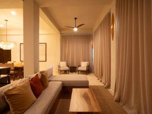 a living room with a couch and a table at Casa Sur – Oceanfront Villa in Placencia +35 photos