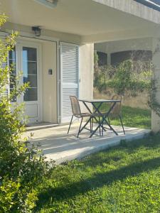 a table and two chairs sitting on a patio at Studio Venaco Centre Corse in Venaco +5 photos
