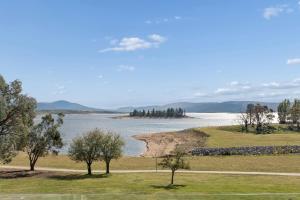 a view of a body of water with trees at Horizons 302 in Jindabyne