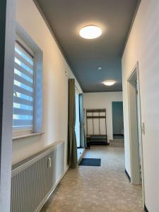 a hallway with a room with a window and a door at Ferienwohnung Freedom 3 Terrasse High End in Northeim