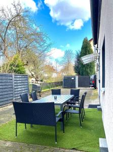 a table and chairs sitting on a lawn with a table and chairs at Ferienwohnung Freedom 3 Terrasse High End in Northeim