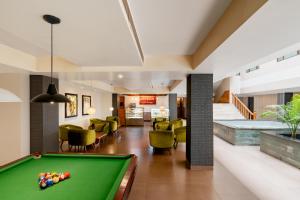 a pool table in the middle of a living room at Classic Grande,a Member of Radisson in Imphal