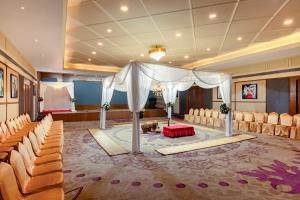 a room with a tent and chairs and a stage at Classic Grande,a Member of Radisson in Imphal +32 photos