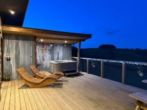 a deck with two chairs and a grill on a house at Bryn Hafod in Llandrindod Wells +17 photos