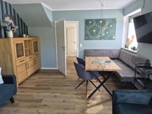 a living room with a table and a couch at Haakestrasse 1j in Dahme