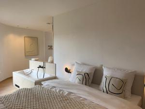 a bedroom with a large bed and a table at Wasserturm Hotel Elsenborn in Butgenbach