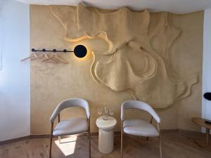 two chairs and a toilet in a room with a wall at Wasserturm Hotel Elsenborn in Butgenbach +122 photos