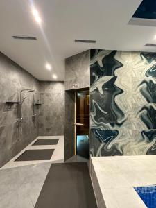 a bathroom with a shower and a wall mural at TURAN HOTEL in Aktau