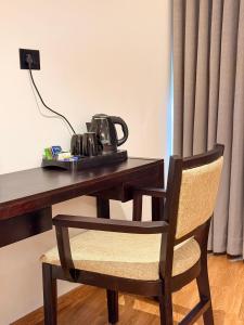 a telephone sitting on top of a wooden desk at The Residence by Chakolas Pavilion in Cochin
