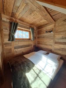 a bedroom with a bed in a wooden cabin at Chalet La Grange à Philippe in Evolène